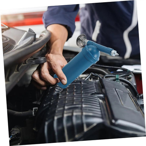 Mechanic using Mini Grease Gun 80cc With Locking Nozzle Manual Lubrication Tool For Excavators Cars And Industrial Equipment on engine