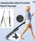 Person moving a foldable 32 Inch Digital Signage Display Portable LCD Kiosk For Advertising Posters Android Kiosk With Auto Media Player