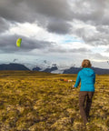 Person flying Synapse 140 Dual Line Parafoil Kite For Beginners And Modern Flyers, Easy Setup And Quick Pack in windy landscape.
