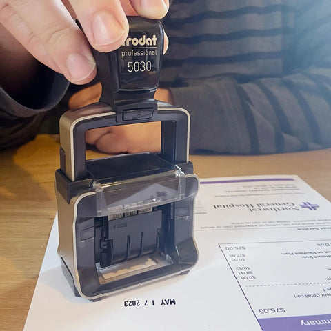 Heavy Duty Self Inking Date Stamp Built Tough For Busy Shops And Stores Runs Smooth With Zero Mess covering a document.