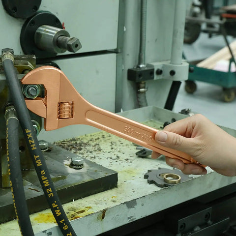 Hand using a beryllium copper 300mm pipe wrench from 36 Piece Non Sparking Tool Set For Pro Grade Jobs, non-magnetic and corrosion-resistant