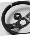Black Riser Adapter Plate for Racing Cars alongside a steering wheel, durable bolt on car accessory for style and fit.