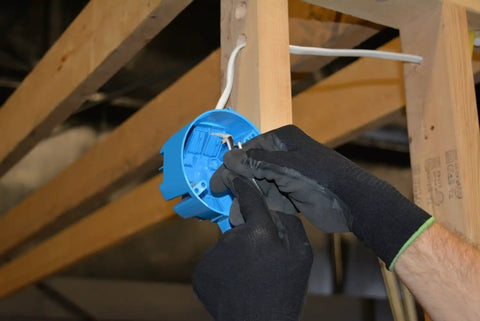 Electrician installing Fourteen Gauge Two Conductor Romex NM B Indoor Building Wire With Ground Fifty Feet Long 600 Volt Rating 90 Degree Celsius