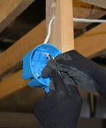 Gloved hands installing 14/2 With Ground NM-B Indoor Cable, 250 Ft Dry Location Romex Style Electrical Wire into a junction box.
