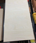Top Tier Baltic Birch Plywood Sheets, 1/8 Inch Thick, Smooth BB Grade Face, CNC Router And Engraving Ready, Badass Smooth Finish For Handmade Crafts, Bulk Pack Of 20 on a cutting table.