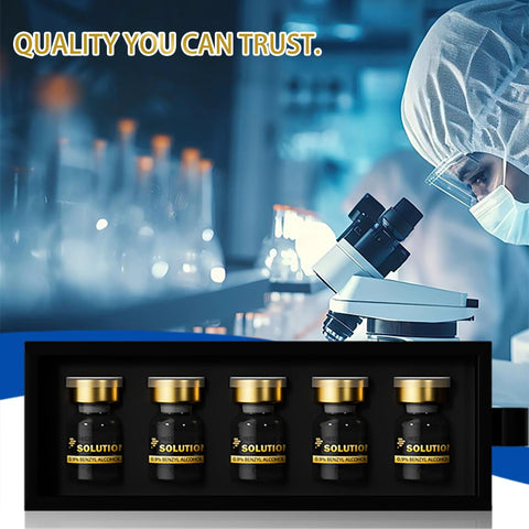 Five premium glass vials with gold caps in a black display tray, lab scene with a microscope.