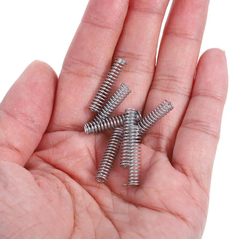 Dope Mini Stainless Steel Compression Spring Kit With 100 Practical Assortment Parts For Easy DIY Home Fix And Car Repair Projects That Actually Stick Around. Mini stainless steel compression springs in hand for DIY repair