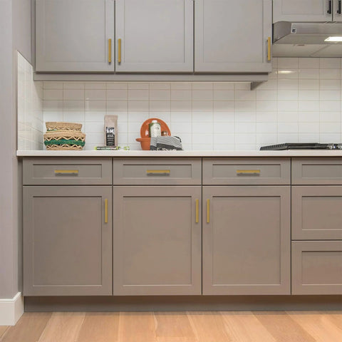 Kitchen cabinets with gold stainless steel cabinet pulls, square drawer handles set of 2, installed on grey doors.