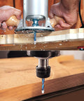 Hands using a flush trim router bit for precise wood shaping, showcasing its spiral design for clean cuts in wood.