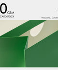 Close-up of green 230 gsm cardstock from Bulk 10 Pack Paper Gift Bags With Satin Ribbon Handles Assorted Colors Small Gift Wrapping Set.