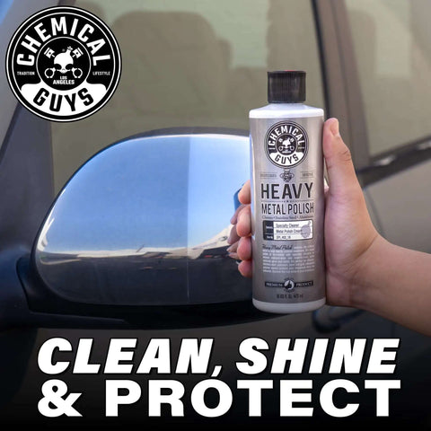 Hand holding Heavy Metal Polish Restorer and Protectant for Chrome Aluminum Stainless Steel Brass Silver and more near car mirror