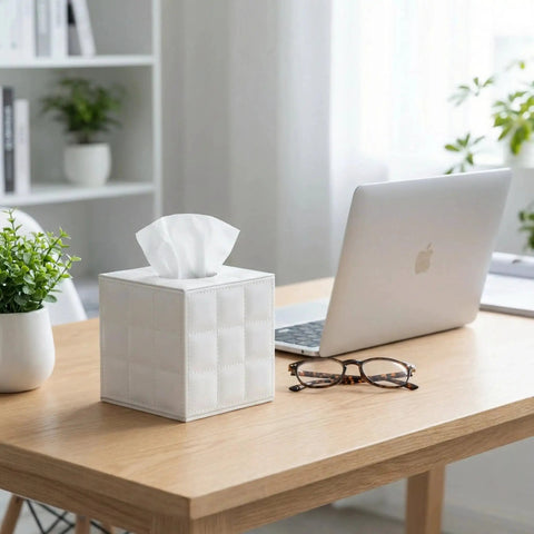 Leather Square Tissue Box Cover With Magnetic Closure For Bathroom Vanity And Desk Modern White Grid Organizer Decorative Tissue Holder For Nightstand Bedroom And Office on a wooden desk beside a laptop and glasses.