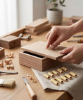 Ten Pack Brass Hidden Cabinet Hinges M8x18mm next to hands assembling wooden box on table