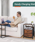 Compact Nightstand With Charging Station And USB Ports beside a man relaxing on a sofa, featuring fabric drawers and storage shelf.