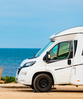 Heavy Duty Rubber Wheel Chocks Four Pack For RVs And Trailers, Tough As Nails Grip beneath RV parked at beachside