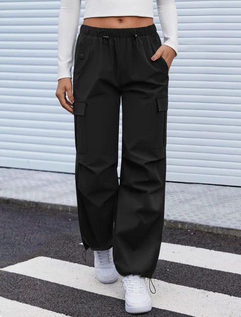 Women's Cargo Hiking Pants With Elastic Waist, Water Resistant Quick Dry Parachute Style Baggy Fit, Black Size M on model.