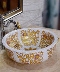 Slick White Ceramic Vessel Sink For Above Counter Bathroom Vanity With Top Shelf Glossy Glaze And Dead Simple Cleanup Round Art Bowl Shape Durable Porcelain with gold floral design.