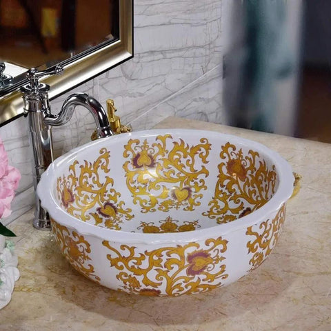 Slick White Ceramic Vessel Sink For Above Counter Bathroom Vanity With Top Shelf Glossy Glaze And Dead Simple Cleanup Round Art Bowl Shape Durable Porcelain with gold floral design.