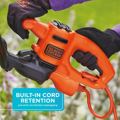 User holding Powerful 3.0 Amp Electric Hedge Trimmer With 16 Inch Blade Lightweight Compact Corded Yard Tool For Quick Clean Shrub Shaping And Pruning Includes Cord Retention