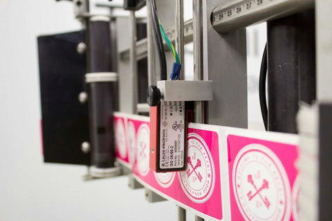 Heavy Duty Compact Modular Label Applicator Built Tough For Relentless Shifts Runs Smooth, sensor and label alignment close-up.