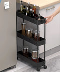 Space Saving Slim Storage Cart With 3 Tier Rolling Utility Smart Organizer Fits Tight Spots In Narrow Gaps In Bathroom Kitchen Laundry Or Office Black shown in a kitchen setting
