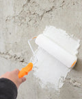 Applying Self Leveling Epoxy Floor Kit with roller on concrete wall for DIY and commercial refinishing