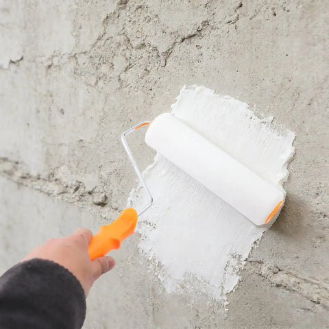 Applying Self Leveling Epoxy Floor Kit with roller on concrete wall for DIY and commercial refinishing