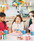 Kids at a birthday party with Sturdy 5oz Disposable Paper Cups Bulk 1200 Pack For Cold Drinks on a table with a cake.