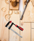 Heavy Duty 6 Inch F Clamp With Quick Adjustment And Antirust Finish For Welding Projects and Workshop Environments Featuring One Hand Operation and Durable Metal Bar Design Perfect For Woodworking and DIY Builds on wooden workbench.