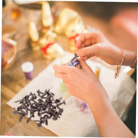 Hands using 50 Pack Miniature Metal Fasteners and Close Pins for Scrapbooking Card Making and Craft DIY Brads Paper Fasteners