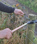 Heavy Duty Fence Wire Tightener Tool Barbed Wire Tensioner for garden and farm fences being used on outdoor fence post