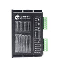 Front view of a DM856 microstep driver module; black rectangular controller with green terminal blocks on the side.