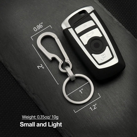 Titanium Carabiner Keychain with Quick Release Clip and car key, 2-inch, lightweight, rustproof, grey finish, on dark surface.