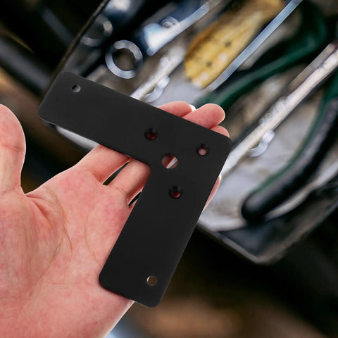 10 Pack Heavy Duty L Shaped Corner Brackets In Black Stainless Steel With Smooth Edges shown in hand.