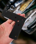 Close-up of a Beefed-Up Heavy Duty L Shaped Corner Bracket in Black Stainless Steel held in hand, showing hole placement.