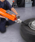 Person using All Purpose Tire Seater And Inflator Tool 8 L Portable Air Blaster with 120 PSI Max on truck tire