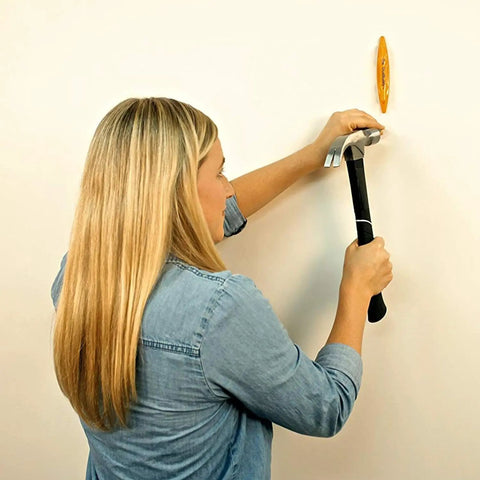 Woman using a hammer with Magnetic Stud Finder Thats Easy To Use No Batteries Made In The USA Powerful Magnet Locates Drywall Studs Fast