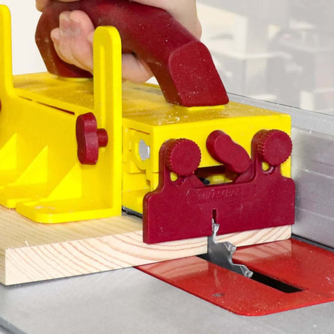 Milescraft 3406 GrabberPRO push block for table saws; yellow plastic with red adjustment knobs guiding wood pieces