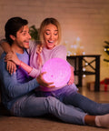Couple holding Moon Lamp 3D Printed Lunar Light with Black Stand 3.5 Inch Night Light USB Charging in cozy living room