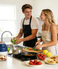 Upgrade Electric Garlic Chopper With Six Stainless Steel Blades Portable Mini Food Processor For Mashing Onions Chili And Meat being used by two people in a bright kitchen.