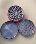 Open pink spice grinder with metal grinding chambers for herbs and spices, 2.5 inch portable size, compact travel design