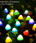 Mushroom Solar String Lights 20-Pack, 37.7ft Fairy Color Changing Outdoor Pathway Lights With 8 Modes lighting up a garden at night.