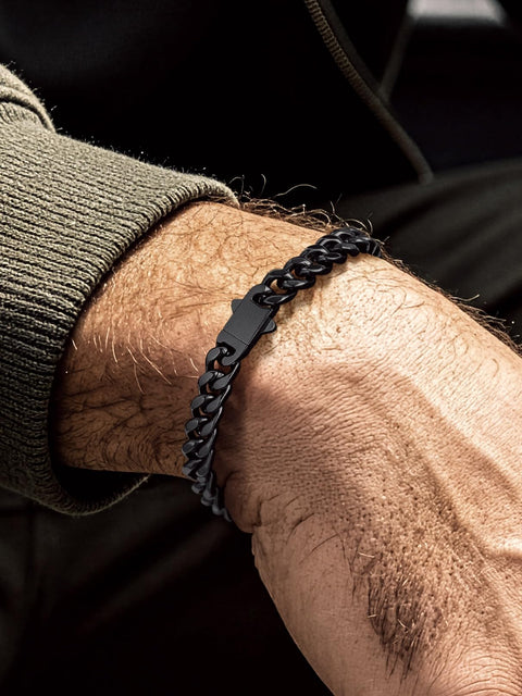 Man wearing Black Stainless Steel Cuban Link Chain Bracelet For Men And Women 7mm Rope Chain With Fold Over Clasp