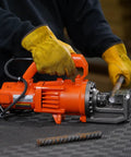 Benner Nawman Dc-20Wh Portable Heavy-Duty Rebar Cutter in use, cutting a 3/4 inch steel reinforcing bar on a job site.