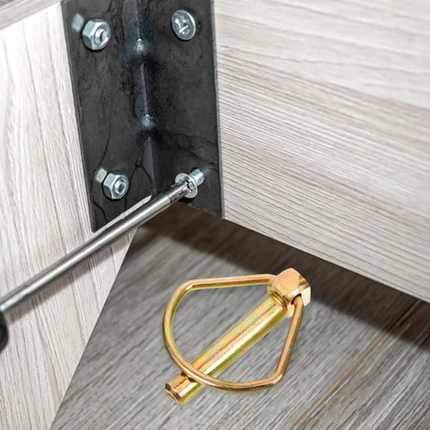 Close-up of heavy duty linch pin with ring made of tough carbon steel for tractor and trailer use.