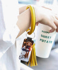 Person holding cup with wrist strap showing PU leather Sublimation Keychain Blanks Set with dog print