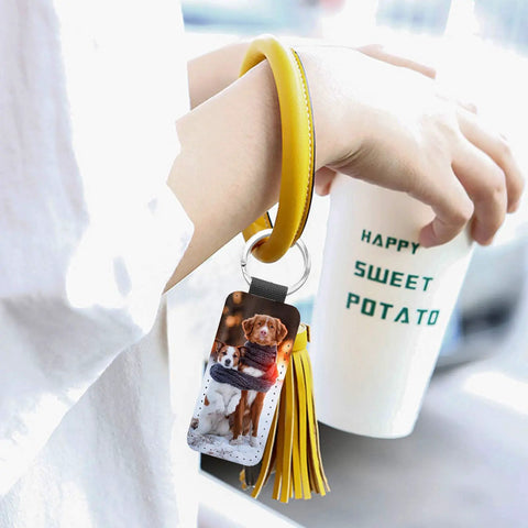Person holding cup with wrist strap showing PU leather Sublimation Keychain Blanks Set with dog print