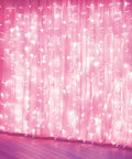 Pink Curtain Lights With 8 Modes LED String Lights for bedroom decor, 6.6 ft draped on wall, creating warm ambience.