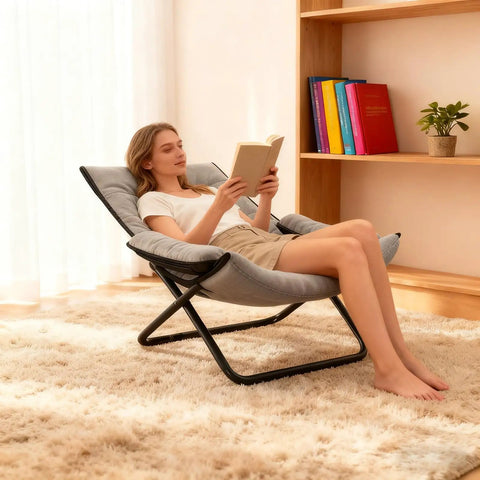 Woman reading on a Three Position Adjustable Folding Recliner Chair With Ottoman And Armrests For A Comfy Portable Lounge In Gray