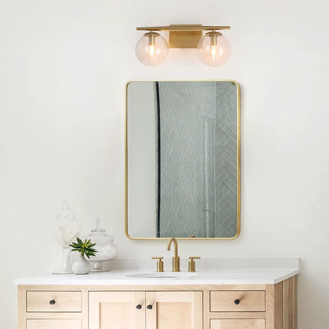 Gold Vanity Light 2-Light Fixture With Globe Clear Glass Shades For Bathroom, mounted above mirror